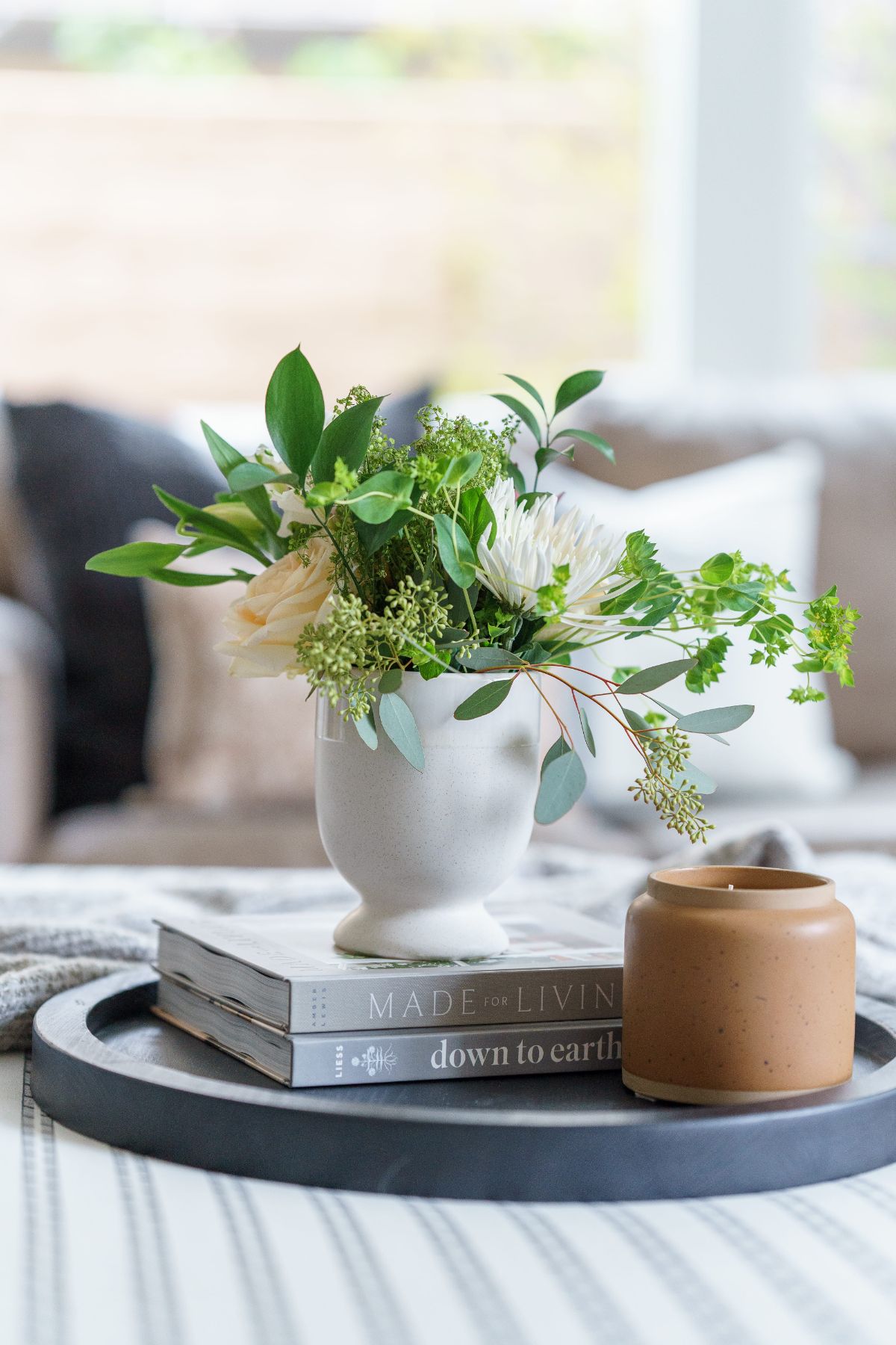 potted plan in vase on books, staged on a table by Residential Interior Designer Sloan Co Design