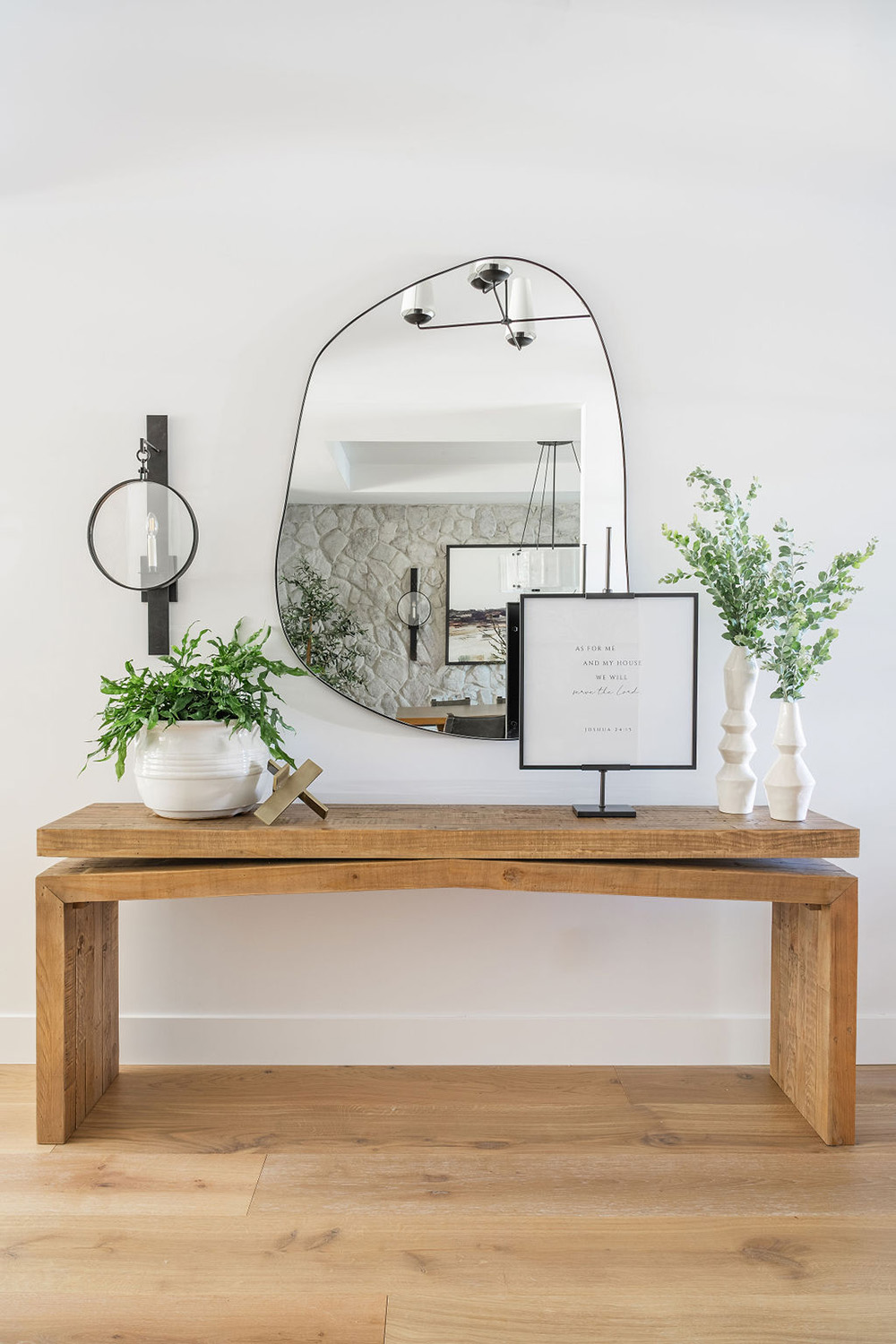 entry way table with plants, artwork and organic-edged mirror design
