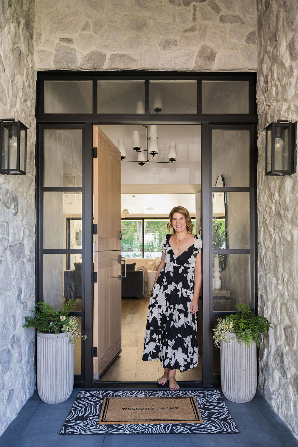 designer Amanda Sloan standing in the doorway of a home she designed