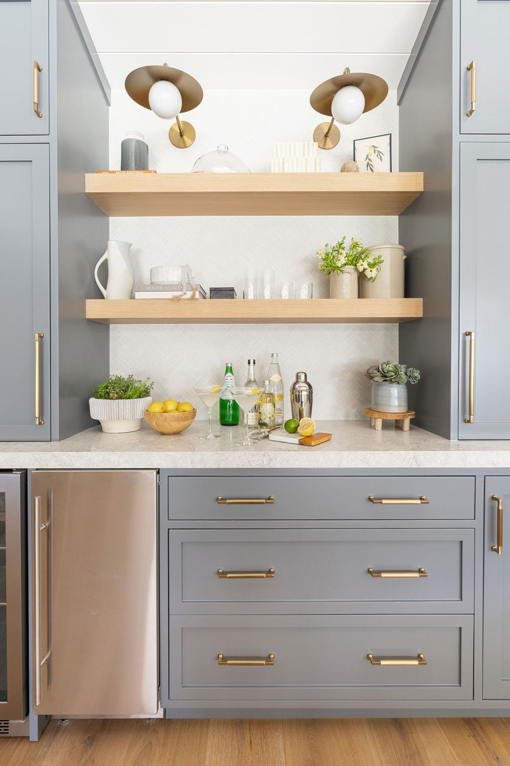 bar area design in livingroom with gray cabinets and light gray textured counter top