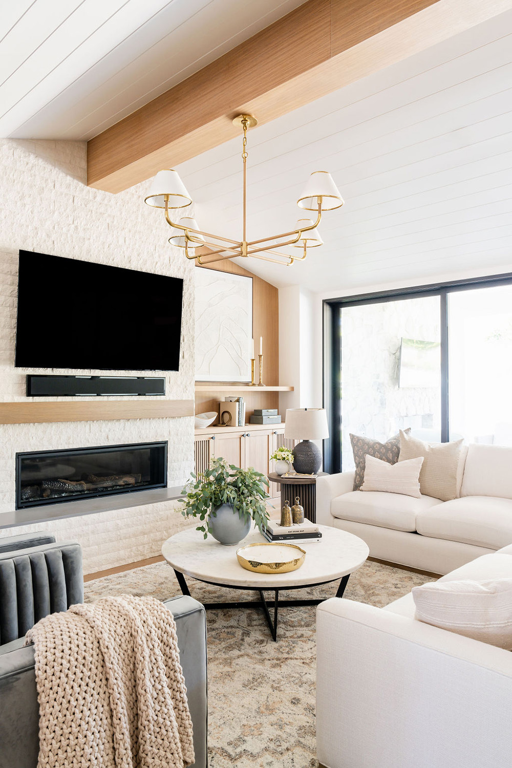 bright living room design with unique gold light fixture