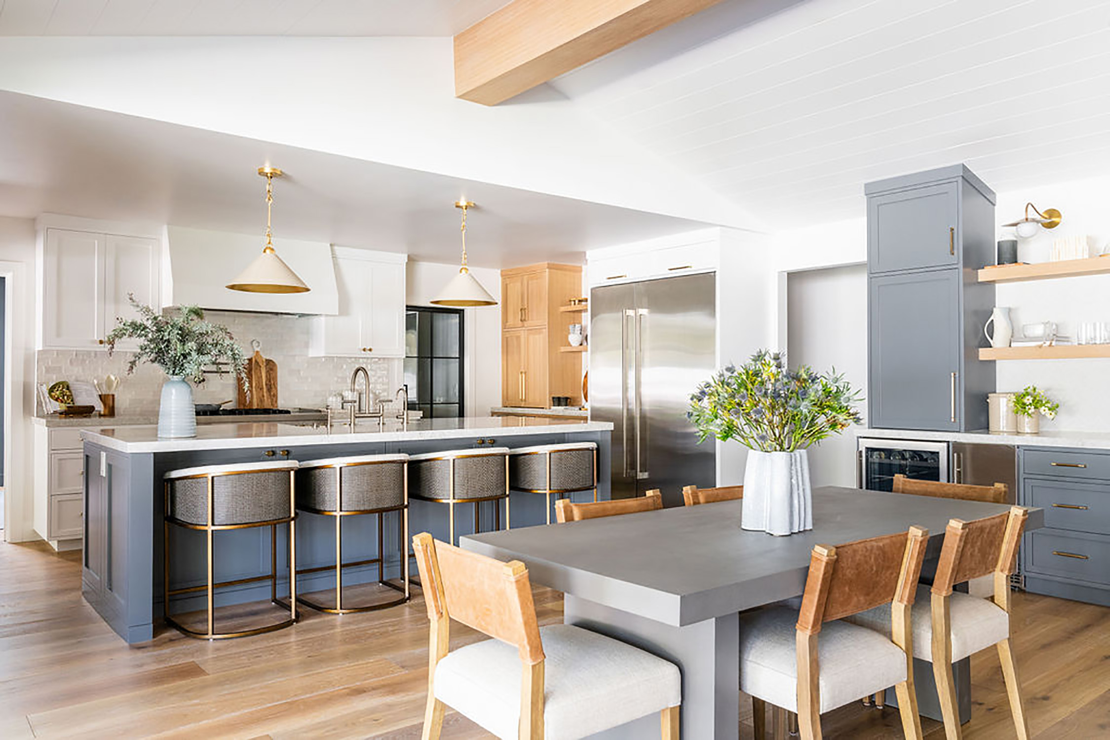 modern bright kitchen design with open beam ceiling and hanging lights over the island