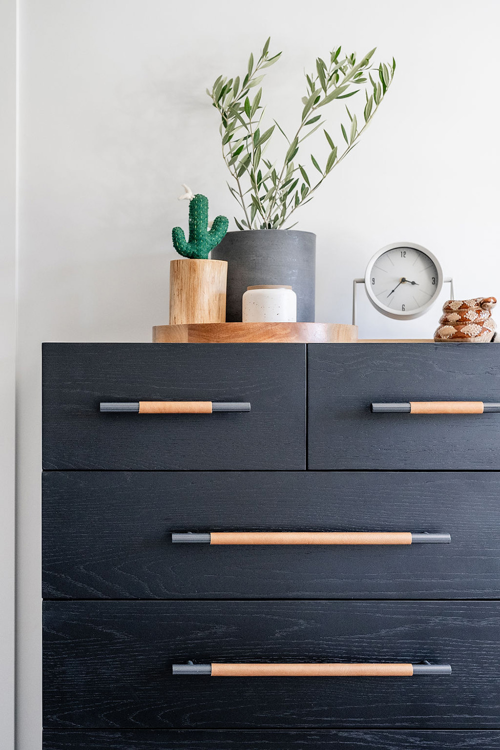 bedroom detail with black dresser and decor