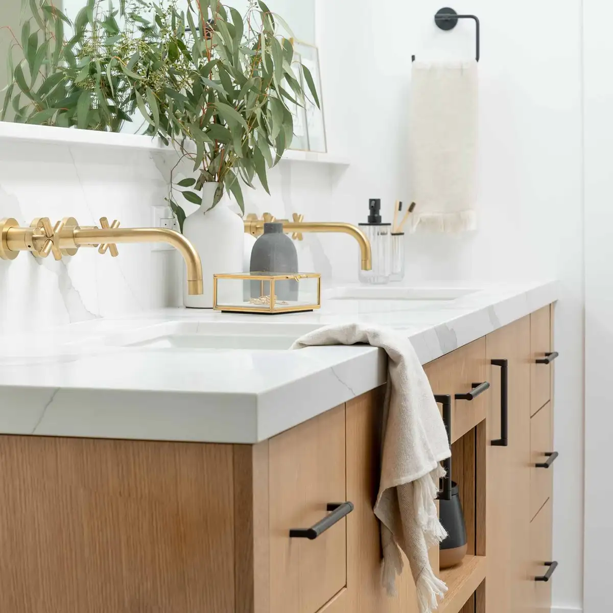 Bathroom Interior Design details of a sink surface with gold fixtures and a plant