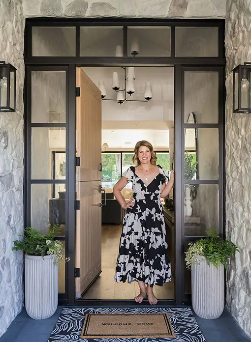 Interior Designer Amanda Sloan standing in a doorway of a home she designed