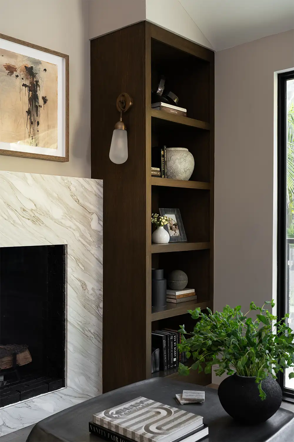 interior design details featuring warm dark wood cabinetry, sconce lighting, nad mixed materials